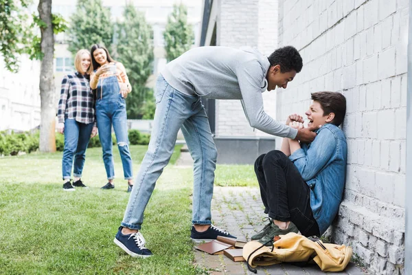 African american boy in hoodie and jeans bulling boy and teenager shooting it — Stock Photo