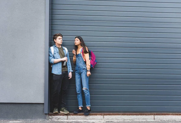 Boy and brunette teenager, smoking cigarette and holding beer — Stock Photo