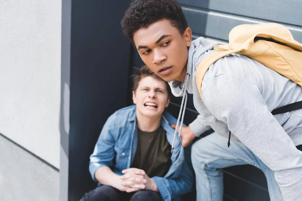 Selective focus of african american boy in hoodie and jeans bulling screaming and scared boy — Stock Photo