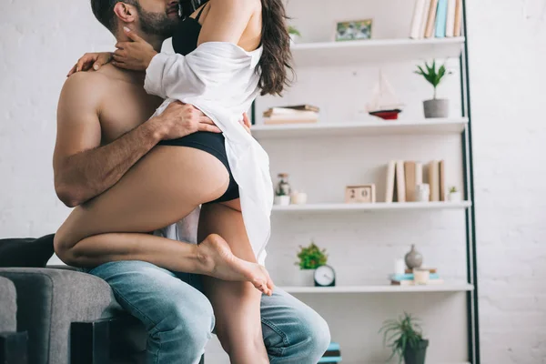 Cropped view of shirtless man hugging with sexy woman in shirt — Stock Photo