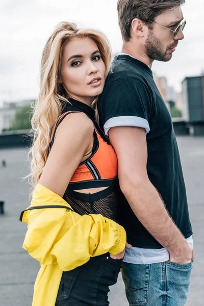 Blonde et séduisante femme en veste jaune avec bel homme en lunettes — Photo de stock