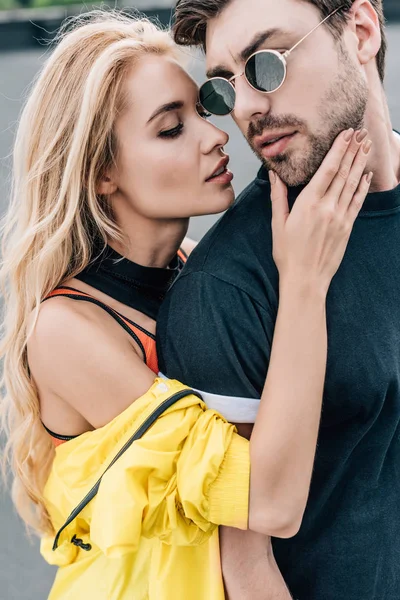 Blonde and attractive woman hugging with handsome man in glasses — Stock Photo