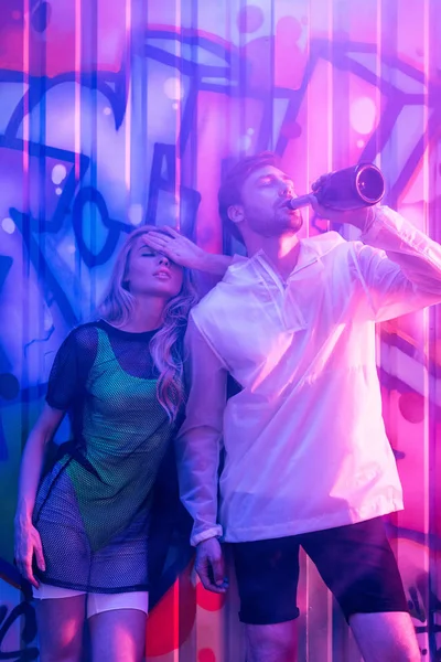 Attractive and blonde woman with closed eyes and handsome man drinking champagne — Stock Photo