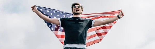 Panoramic shot of man in glasses with american flag — Stock Photo