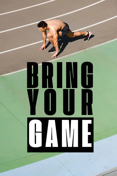 Overhead view of mixed race sportsman preparing to run at stadium with bring your game lettering — Stock Photo