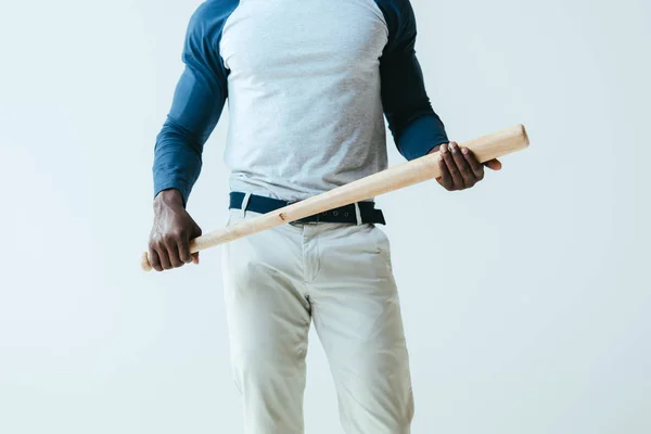 Partial view of african american sportsman holding baseball bat isolated on grey — Stock Photo