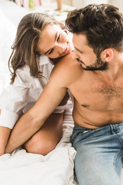 Sexy couple looking at each other and holding hands — Stock Photo