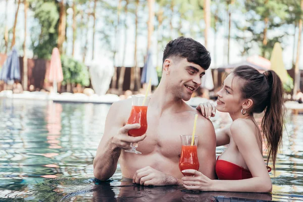 Dos vasos con bebida refrescante de fruta natural en la piscina - foto de stock