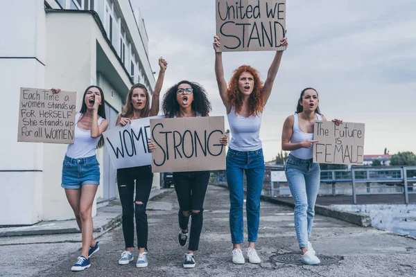 Emotional multicultural women holding placards and screaming outside — Stock Photo