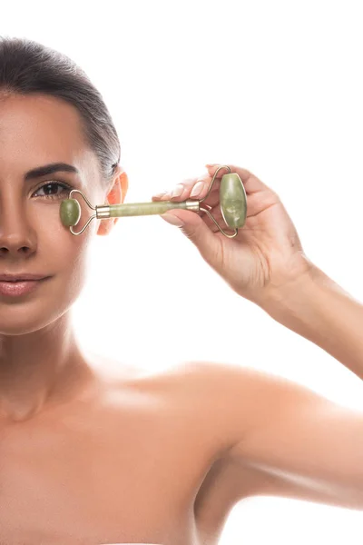 Cropped view of naked young woman using facial jade roller isolated on white — Stock Photo