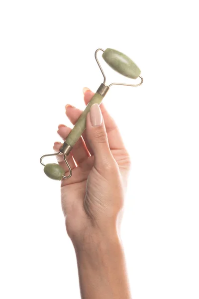 Cropped view of woman holding facial jade roller isolated on white — Stock Photo