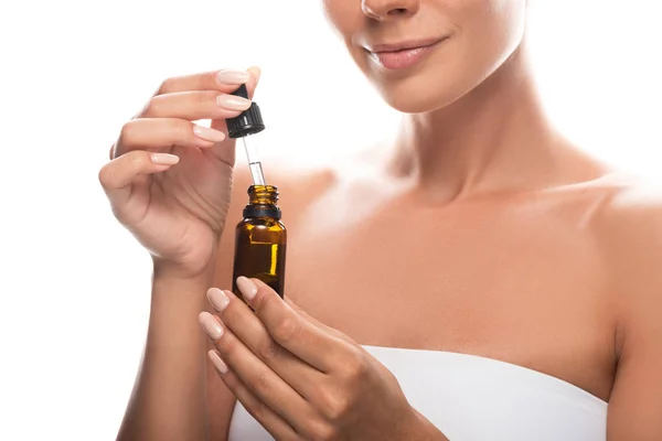 Partial view of young woman holding serum isolated on white — Stock Photo