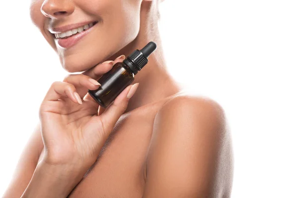 Cropped view of nude young woman holding serum and smiling isolated on white — Stock Photo