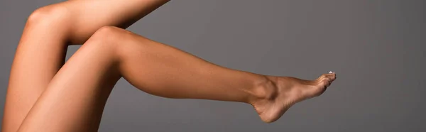 Panoramic shot of sexy barefoot girl isolated on grey — Stock Photo