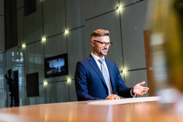 Selective focus of handsome businessman in suit and glasses — Stock Photo