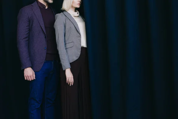 Cropped view of elegant young woman and man near curtain — Stock Photo