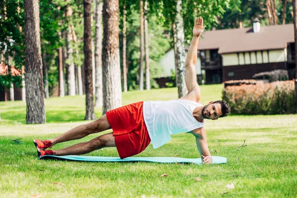 Handsome man in sportswear working out outside — Stock Photo