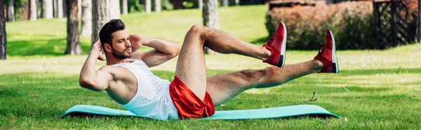 Tiro panorâmico de desportista barbudo trabalhando em esteira de fitness — Fotografia de Stock