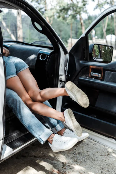 Vue recadrée de l'homme et de la femme faisant dans la voiture moderne — Photo de stock