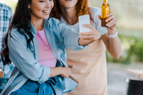 Cropped view of cheerful multicultural girls taking selfie near food truck — Stock Photo