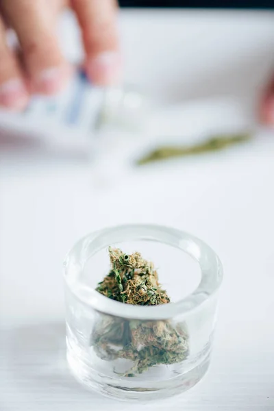 Selective focus of medical marijuana buds on table in apartment — Stock Photo