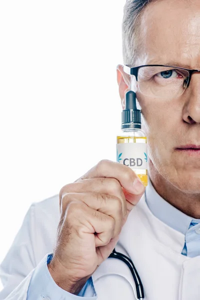 Cropped view of doctor in white coat holding cbd isolated on white — Stock Photo