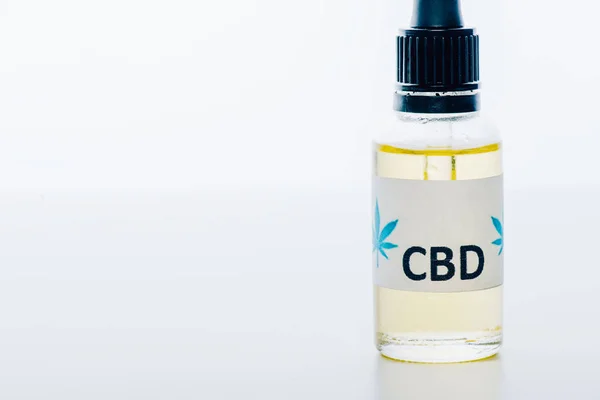 Cannabis oil in bottle with lettering cbd on white background — Stock Photo