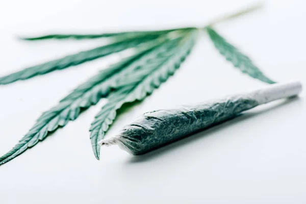 Selective focus of blunt and marijuana on white background — Stock Photo