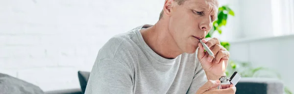 Panoramic shot of man smoking blunt with medical cannabis — Stock Photo