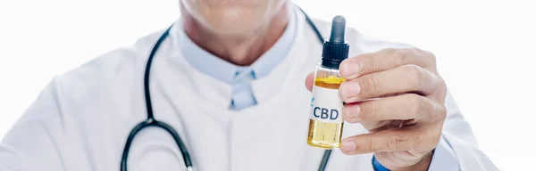 Panoramic shot of doctor in white coat holding cbd isolated on white — Stock Photo