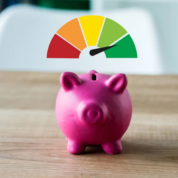 Pink piggy bank on wooden desk near colorful speed meter in office — Stock Photo
