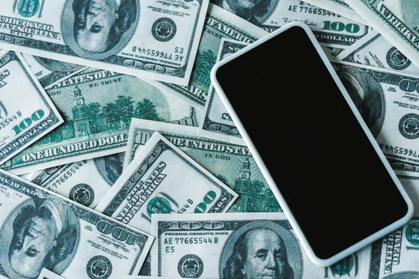 Top view of smartphone with blank screen on dollar banknotes — Stock Photo