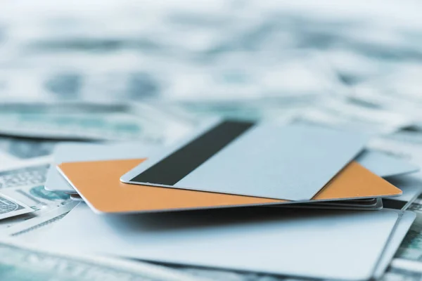 Selective focus of pile with credit cards on dollar banknotes — Stock Photo