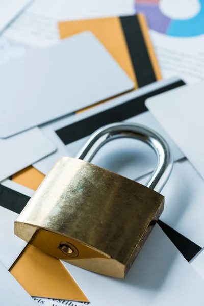 Close up of metallic padlock near credit cards — Stock Photo