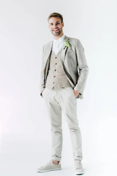 Handsome bridegroom in suit with floral boutonniere looking at camera — Stock Photo