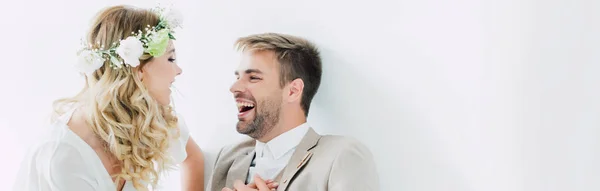 Panoramic shot of attractive bride and handsome bridegroom smiling and looking at each other — Stock Photo