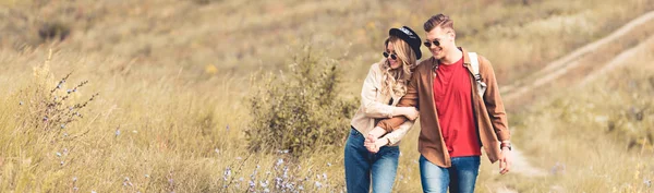Panoramic shot of attractive woman and handsome man smiling and holding hands — Stock Photo