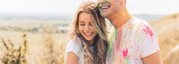 Panoramic shot of attractive woman and man smiling and hugging outside — Stock Photo