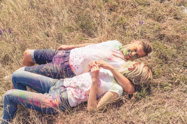 Blonde woman and handsome man smiling and hugging outside — Stock Photo