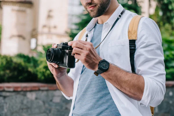 Cropped view of bearded man holding digital camera — Stock Photo