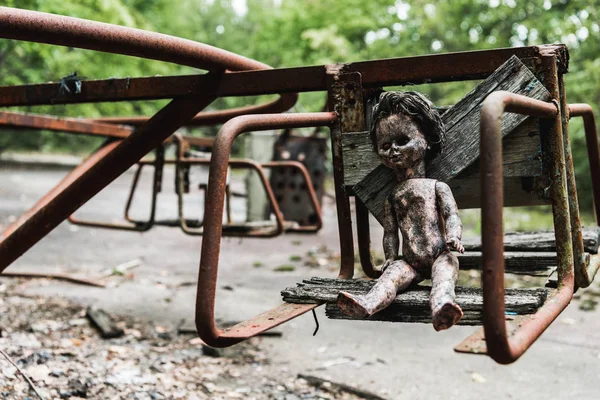 Burnt baby doll on abandoned carousel in chernobyl — Stock Photo