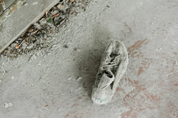 Blick von oben auf verlassene und schmutzige Schuhe auf dem Fußboden — Stockfoto