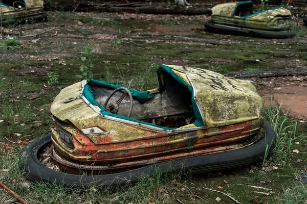 PRIPYAT, UKRAINE - AUGUST 15, 2019: abandoned and damaged bumper cars in amusement park — Stock Photo