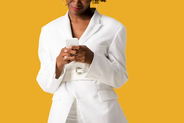 Cropped view of happy african american woman using smartphone isolated on orange — Stock Photo