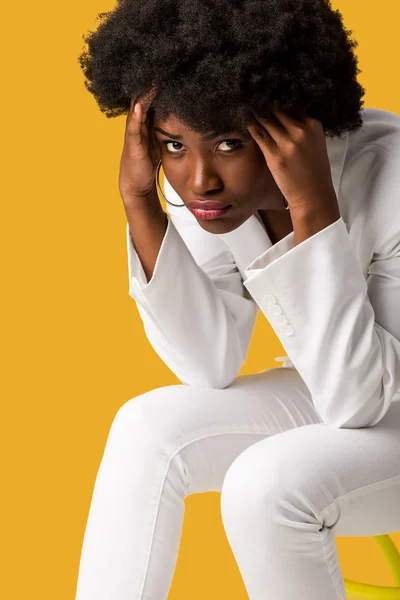 Exhausted african american girl sitting isolated on orange — Stock Photo