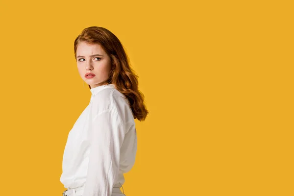 Attractive and young redhead woman isolated on orange — Stock Photo