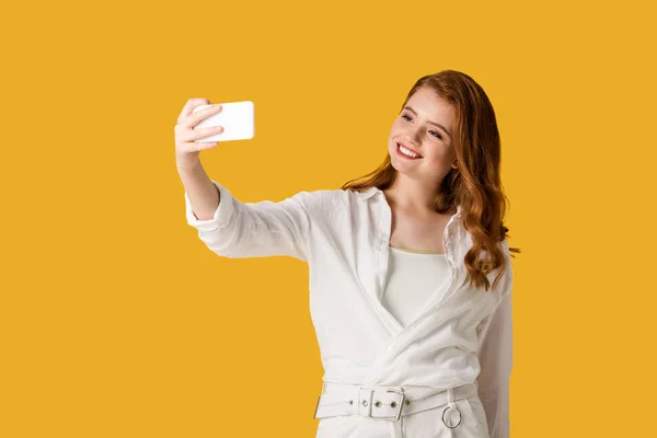 Happy redhead girl taking selfie isolated on orange — Stock Photo