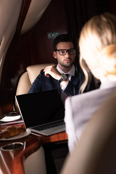 Selective focus on business colleagues in plane — Stock Photo