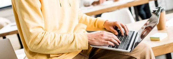 Ausgeschnittene Ansicht eines jungen Geschäftsmannes, der im Büro am Laptop arbeitet, Panoramaaufnahme — Stockfoto