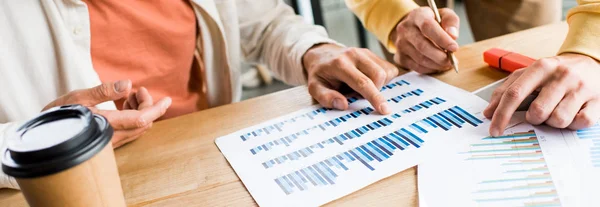 Cropped view of businesspeople analyzing graphs and charts in office — Stock Photo